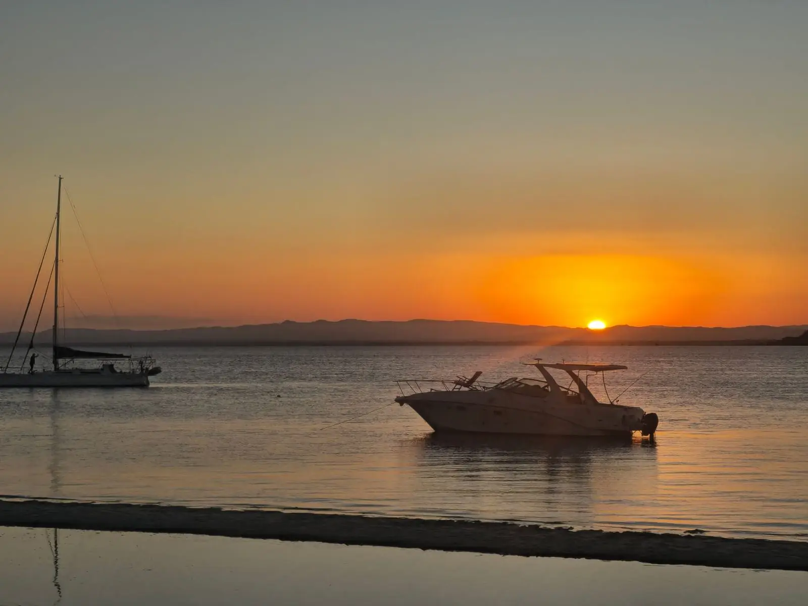 Small boat on calm water near Naples, Florida at golden hour